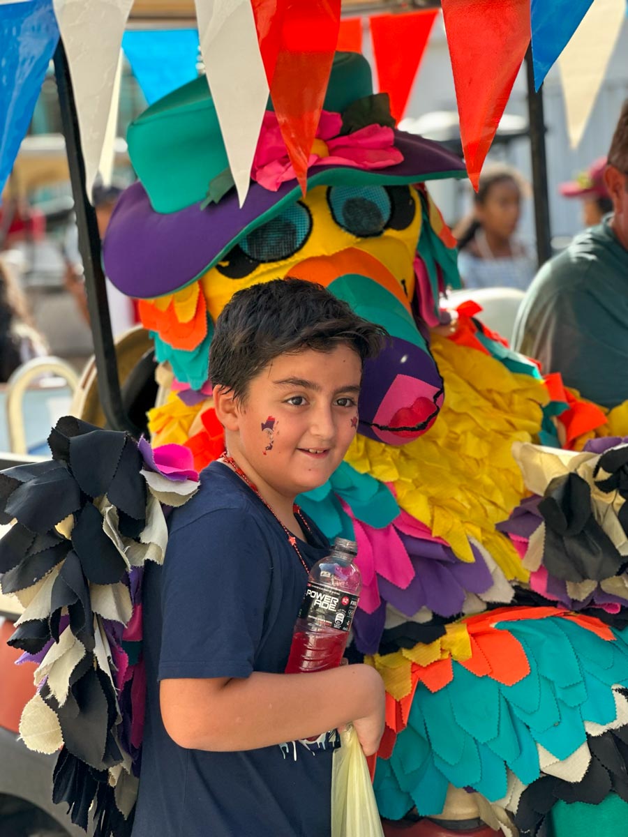 Boy posing with a toucan in parade